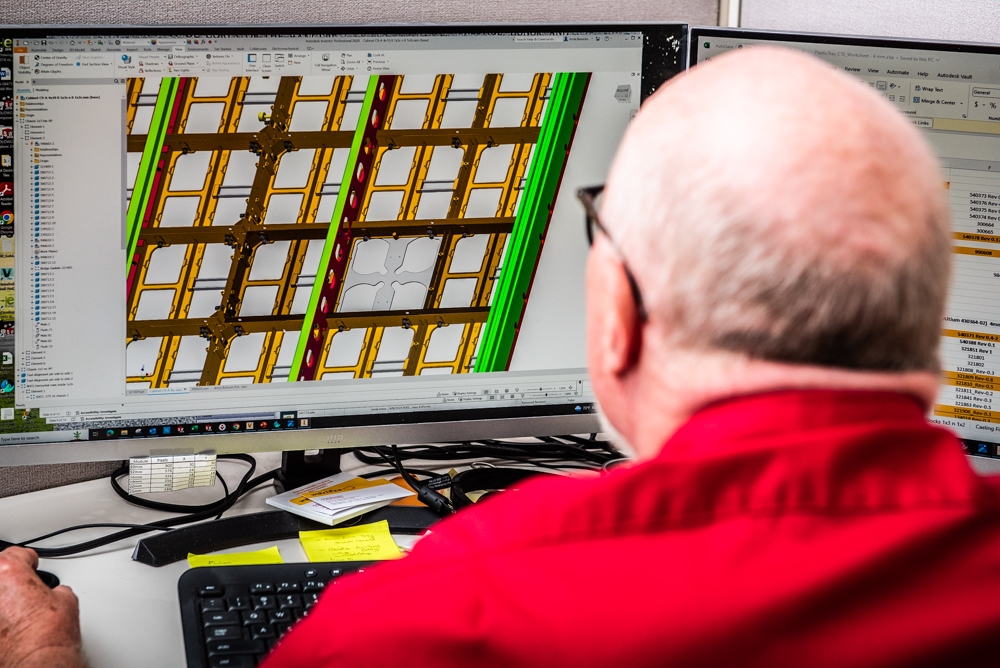 Engineer works on CAD drawing.